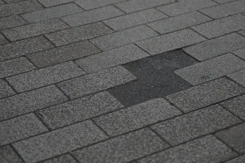 Asphalt shingle roof with missing, wind-damaged shingles